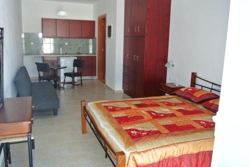 sypialnia z łóżkiem i stołem oraz kuchnia w obiekcie APARTMENTS kokalaki w mieście Kefalos