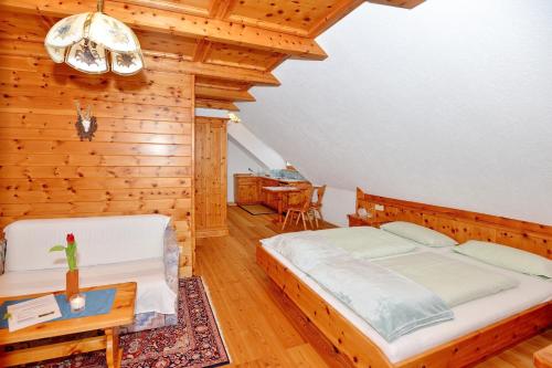 a bedroom with a large bed and a table at Dicktlhof in Ebene Reichenau