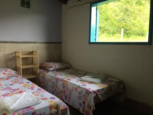 Giường trong phòng chung tại Pousada Estância Macaúbas -