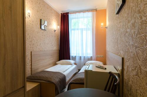 Postel nebo postele na pokoji v ubytování Gogol Park Rooms