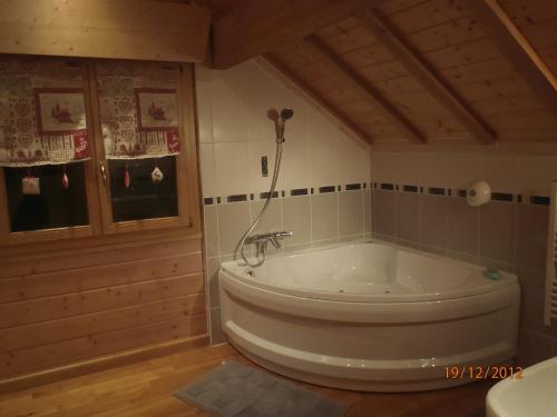 a bathroom with a large tub in a room at Le Chalet du Pont des Fées - Sauna & SPA in Gérardmer