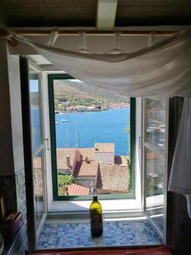 a window in a room with a view of the water at Buena Vis-ta Apartments with the Sea View in Vis