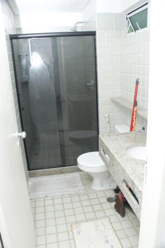 a bathroom with a shower with a toilet and a sink at Ancorar Flat Resort 5202 in Ipojuca