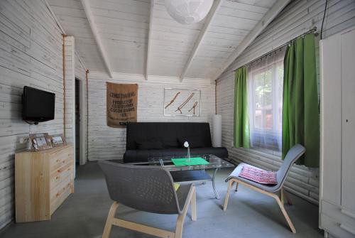 a living room with a couch and a table at Letnisko BAJKA in Iława