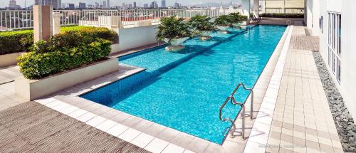 a large swimming pool on top of a building at Your HOME @ Princeton Residences, New Manila in Manila