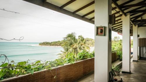a view of the ocean from the porch of a house at Bay Vista in Arugam Bay