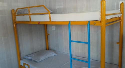 a bunk bed with a ladder in a room at vrs dormitary in Mysore