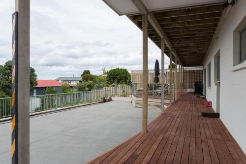 a deck with awning on a house at Ocean View B&B in Whitianga