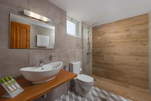 a bathroom with a sink and a toilet at Milos Villas Complex in Pefki Rhodes