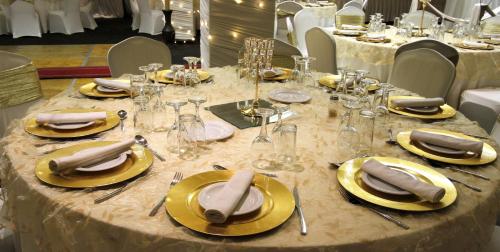 a table with yellow plates and napkins on it at Coastlands Durban Self Catering Holiday Apartments in Durban