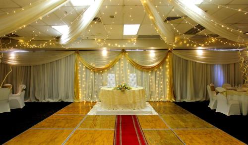 a banquet hall with a table with a cake on it at Coastlands Durban Self Catering Holiday Apartments in Durban