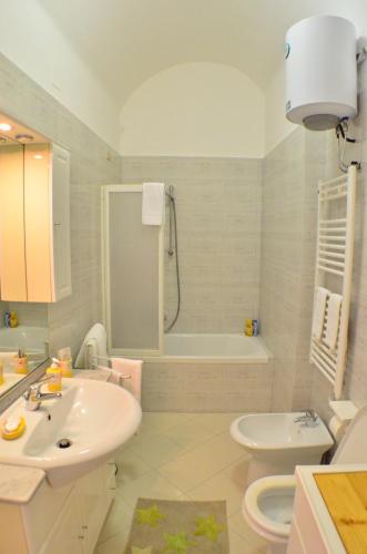 a bathroom with a sink and a toilet and a tub at Il Cucù Bed and Breakfast in Matera