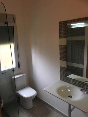 a bathroom with a toilet and a sink at Holiday Apartment with Pool in Tarragona