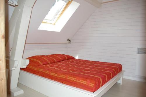 サン・ジョリオにあるAngel Services - La Tuilerie 6の赤い掛け布団付きのベッド1台