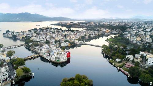 an aerial view of a city on the water at Oolala - Your lake house in the center of Udaipur in Udaipur