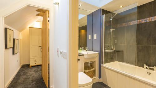 a bathroom with a toilet and a sink and a tub at Hayloft Edinburgh in Edinburgh