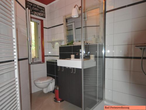 a bathroom with a sink and a toilet at Casa del Sol in Schwielowsee