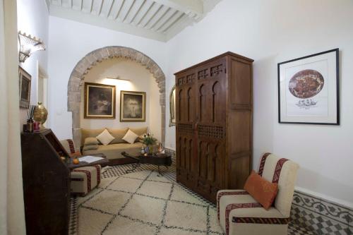a living room with a couch and a large wooden door at Riad Emotion in Essaouira