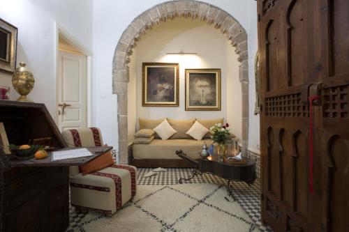 a living room with a couch and a table at Riad Emotion in Essaouira