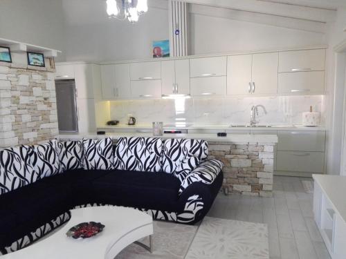 a living room with a couch in a kitchen at Vip Apartment by "Murati" in Ksamil