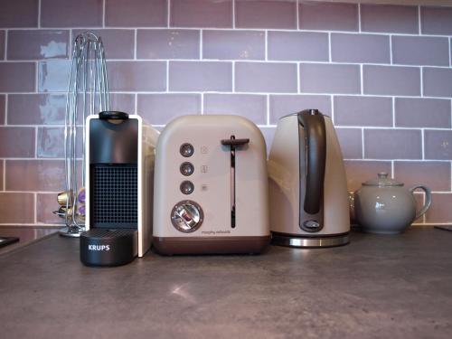 a kitchen counter top with a toaster and a toaster at Argyle Lodge in Rush
