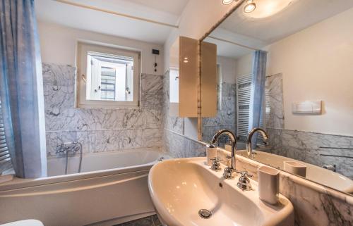 a bathroom with a sink and a tub and a mirror at CA' DEI SCORZERI in Venice