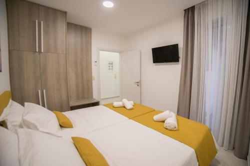 a bedroom with a large bed with towels on it at Bee House in Kissamos