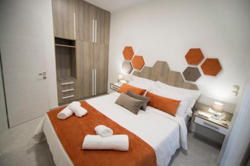 a bedroom with a large bed with towels on it at Bee House in Kissamos
