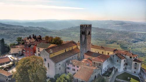 an aerial view of a town with a tower at Istrian Villa Happy House in Nedeščina