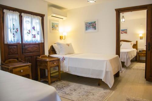 a bedroom with two beds and a mirror at Monza House Otel in Siğacık