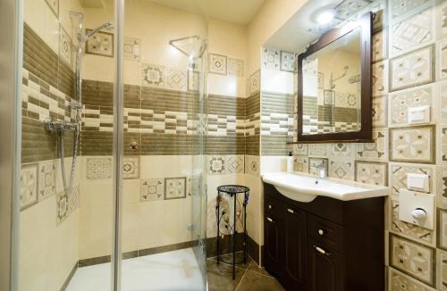 a bathroom with a shower and a sink at VIP апартаменти Ван Гог на площі Ринок in Lviv