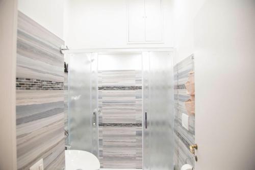 a shower with a glass door in a bathroom at Sweet Sleep Vatican in Rome