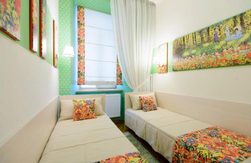 a small room with two beds and a window at VIP апартаменти Ван Гог на площі Ринок in Lviv