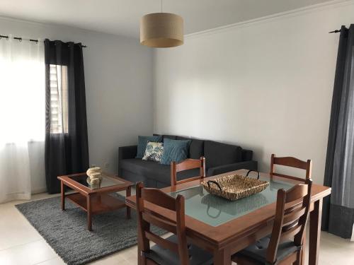 a living room with a table and a couch at Apartamento T&T Ocean - Vista Mar in Portimão