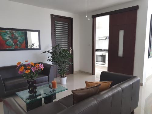 a living room with a couch and a table at Palmagua in Barranquilla