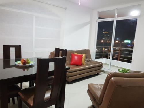 a living room with a table and a couch at Palmagua in Barranquilla
