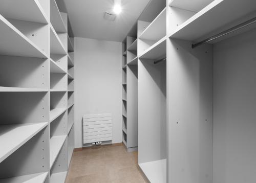 a hallway with white shelves and a door at Aparthotel Residence Grand Špindlerův Mlýn in Špindlerův Mlýn
