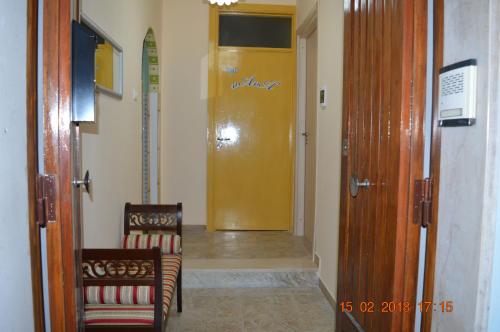 a hallway with two chairs and a yellow door at nAnA' in Orsogna