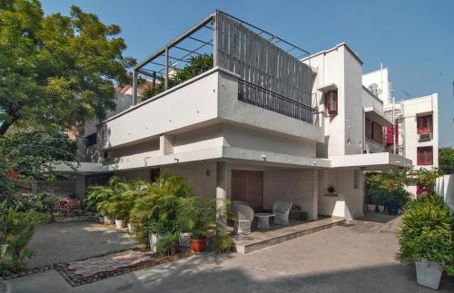a white building with a balcony on top of it at Haveli Hauz Khas in New Delhi