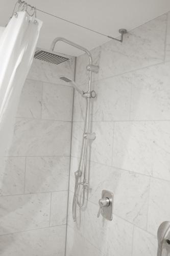 a shower with a shower head in a bathroom at F10 APARTMENTS Ulm in Ulm