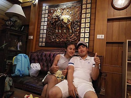 a man and a woman sitting on a couch at Baan Ratchapruek in Phuket Town