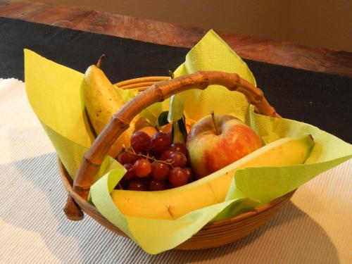 a basket filled with fruit on a table at Les Remparts in Binche
