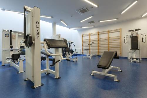 a gym with treadmills and machines in a room at Best Western Hotel Jurata in Jurata