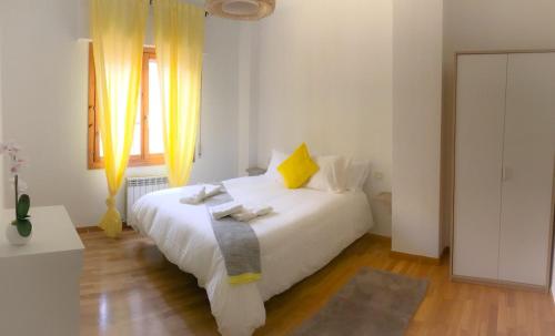 a bedroom with a white bed and a window at AZ El Balcón de Conde de Aranda II in Zaragoza