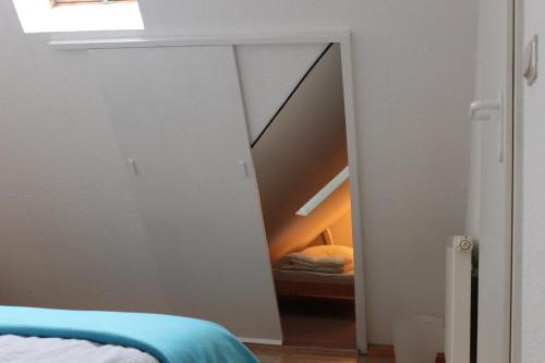 a mirror in a room with a stair case at Warnemünder Strandfieber in Rostock