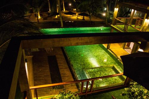 an overhead view of a swimming pool at night at Hikka Sands & SPA in Hikkaduwa