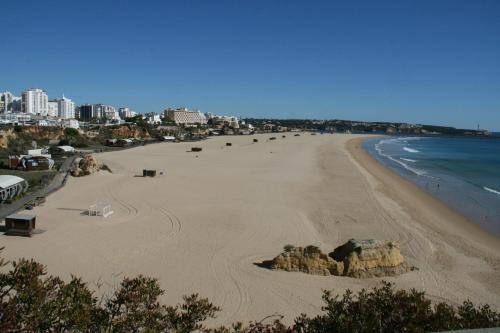 a view of a beach with rocks and the ocean at Apartamento T&T Ocean - Foz Palace Residence Spa in Portimão