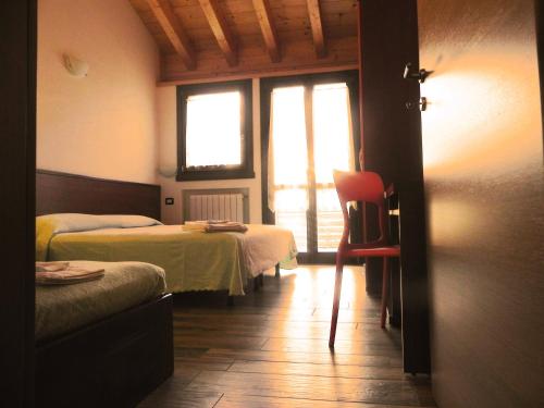 Postel nebo postele na pokoji v ubytování Residence Acero Rosso