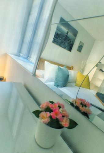 a room with a bed and a vase with flowers at Castle Terrace (B3 R3) in Dudley