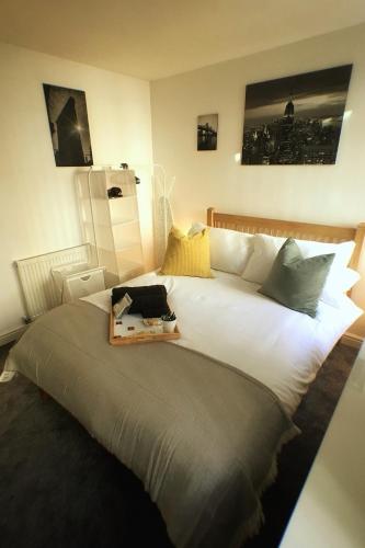 a large white bed with a tray on top of it at Castle Terrace (B3 R3) in Dudley
